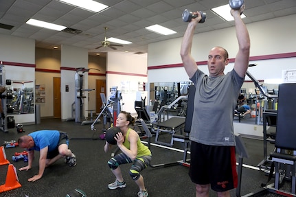 From right, Master Sgt. Neil Herndon, Air Force Band of the West, Becki Powell and husband Master Sgt. David Powell, 37th Training Wing, work out during an Intense Circuit Training class at the Gateway Fitness Center on Joint Base San Antonio-Lackland. (U.S. Air Force photo by Robbin Cresswell/Released)