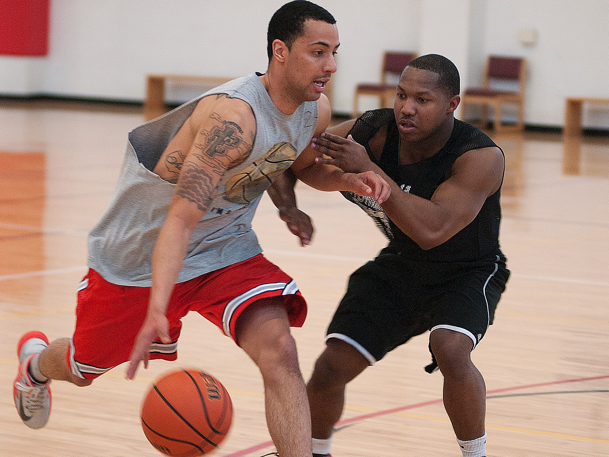 Corey Rucker of team Us tries to get past Uptown’s A.J. Brannon in the last of three hard-fought games the two teams played March 16. Rucker and his teammates went on to win the game, and thus the tournament, 13-11. (U.S. Air Force photo by R.J. Oriez) 