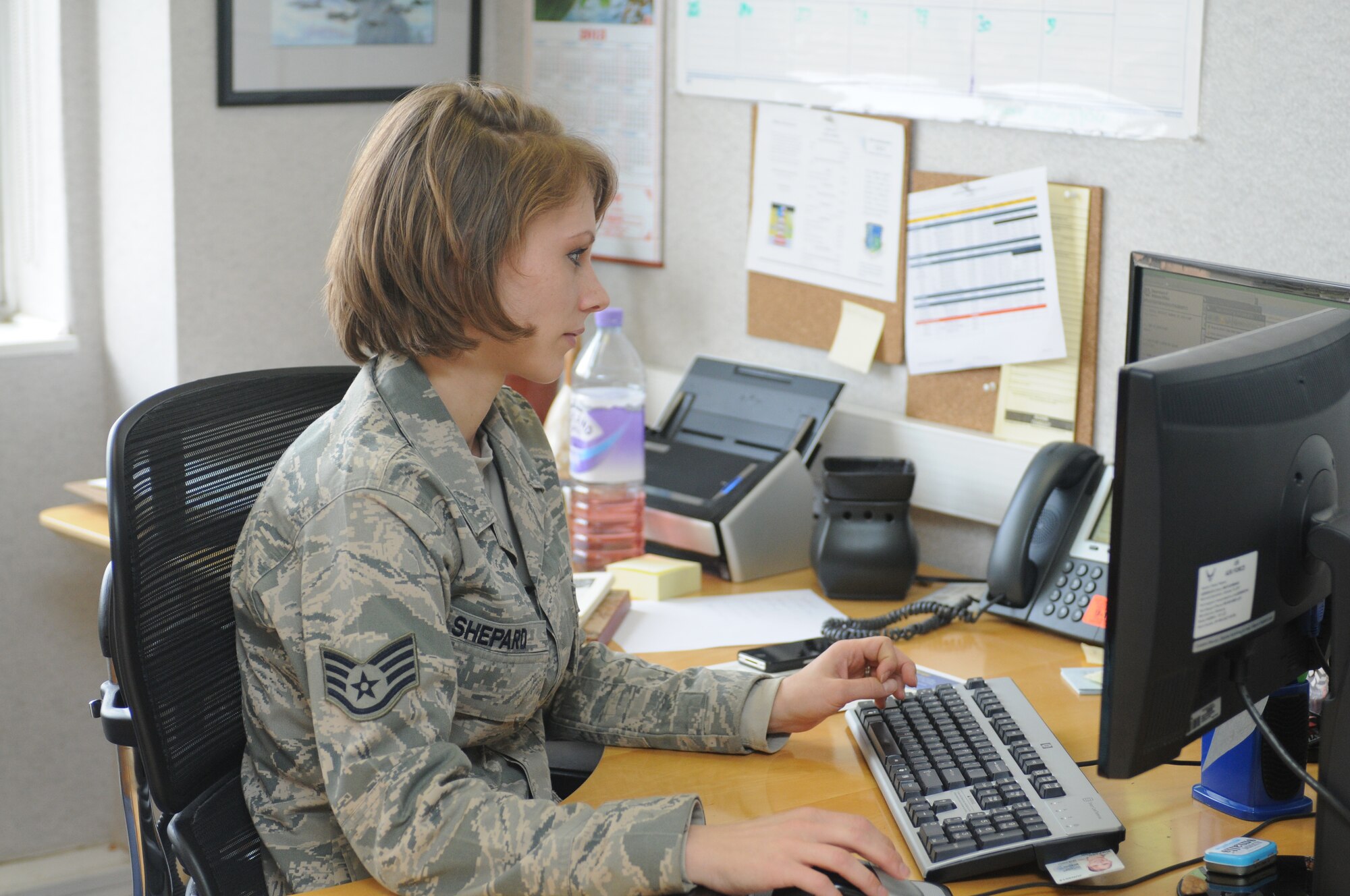 ROYAL AIR FORCE LAKENHEATH, England -- Staff Sgt. Kristi Shepard, 48th Equipment Maintenance Squadron crew chief and NCO in charge of First Term Airmen Center course, schedules mandatory briefings March 13, 2013. Shepard said her favorite part of the job is physical training, "because I get to interact with the Airmen on a personal level. We get to have fun and interact with each other but still in a professional atmosphere." (U.S. Air Force photo by Airman 1st Class Dana J. Butler)