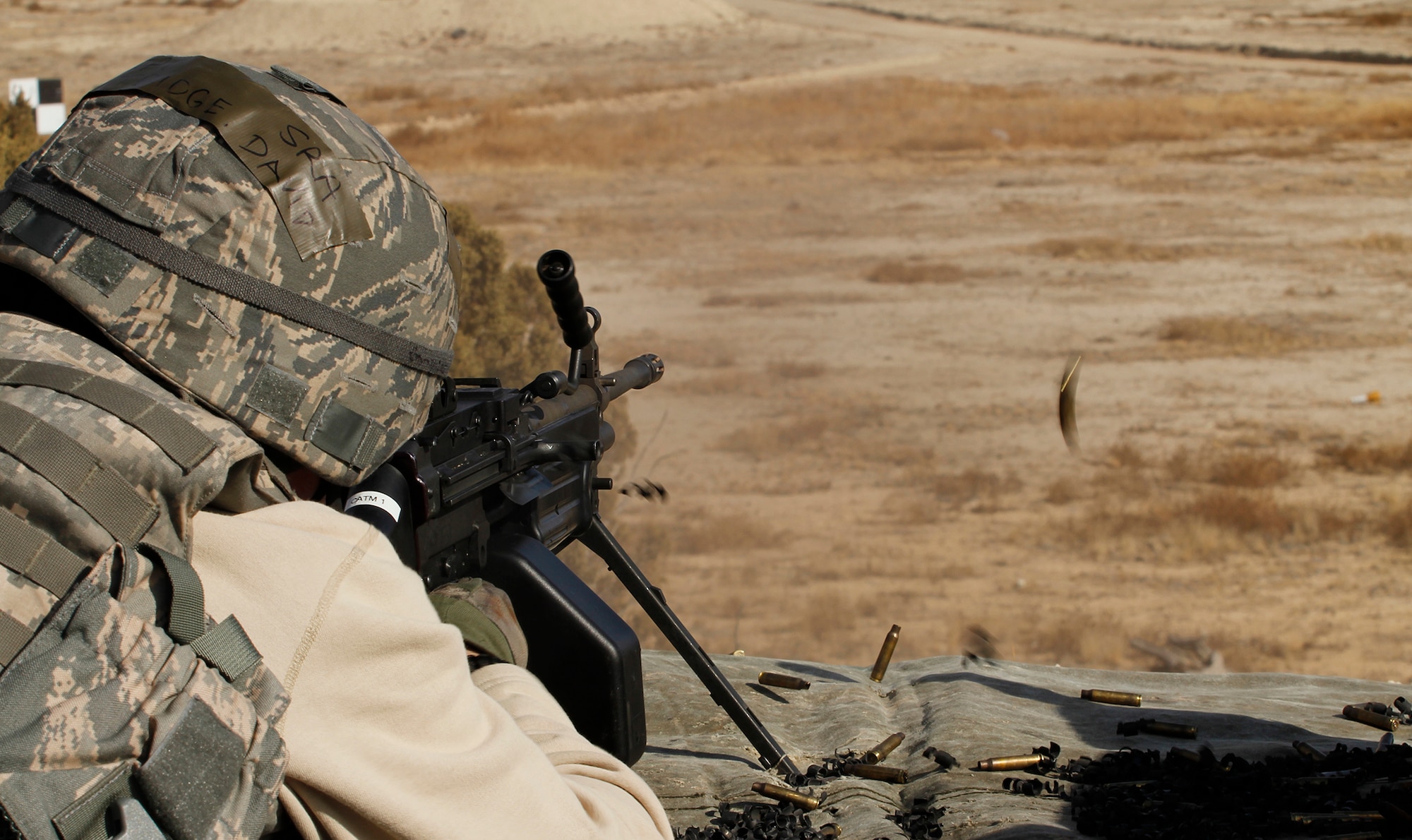 Senior Airman David Eastridge, a fire team member with the 302nd Security Forces Squadron, completes his annual training on the M249 machine gun firing 200 round assault packs of 5.56mm linked ammo. Each Airman fires 550 rounds to qualify on the M249. Security forces spent the February Unit Training Assembly completing their annual training on heavy arms Feb. 10 at Airburst Range, Fort Carson, Colo. (U.S. Air Force photo/Staff Sgt. Nathan Federico)