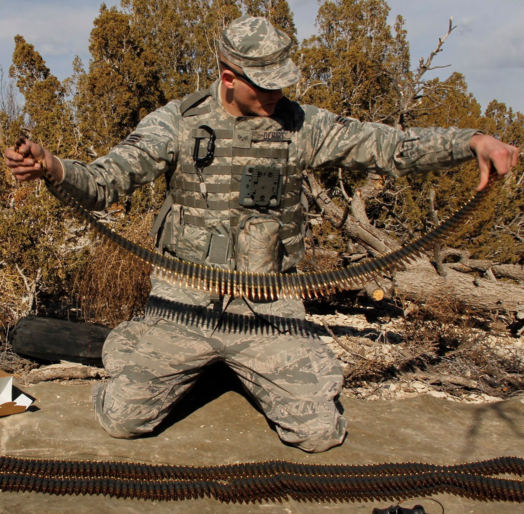 Senior Airman Christopher Dehart, a fire team member with the 302nd Security Forces Squadron, lays out 100 round assault packs of 7.62mm linked ammo for the M240B machine gun. Each Airman fires 1,300 rounds to qualify on the M240B. Security forces spent the February Unit Training Assembly completing their annual training on heavy arms Feb. 10 at Airburst Range, Fort Carson, Colo. (U.S. Air Force photo/Staff Sgt. Nathan Federico)