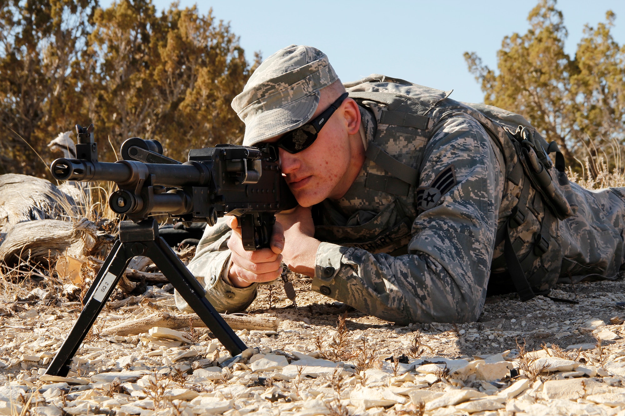 Senior Airman Christopher Dehart, a fire team member with the 302nd Security Forces Squadron, positions a M240B machine gun in the prone position. DeHart and his teammate will each fire 1,300 rounds to qualify on the M240B. Security forces spent the February Unit Training Assembly completing their annual heavy arms training Feb. 10 at Airburst Range, Fort Carson, Colo. (U.S. Air Force photo/Staff Sgt. Nathan Federico)