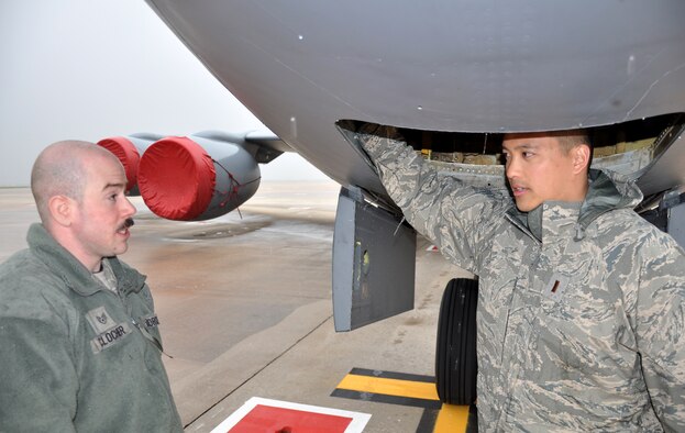 Second Lt. Jonathan Sih opens a panel under a KC-135 Stratotanker while discussing maintenance with Staff Sgt. Jordan Clocher March 22, 2013. Both Airmen are assigned to the 100th Aircraft Maintenance Squadron. Clocher is a Fayetteville, N.C., native, and Sih is a Carrollton, Texas, native. Airmen and aircraft deployed from the 100th Air Refueling Wing, RAF Mildenhall, England, to southwest Europe as the 351st Expeditionary Air Refueling Squadron Jan. 26, 2013. In less than two months, the 351st EARS has completed more than 110 sorties supporting French fighter aircraft conducting operations in Mali. The sorties include more than 1,000 receiver contacts and more than 5 million pounds of fuel transferred. (U.S. Air Force photo by Capt. Jason Smith)