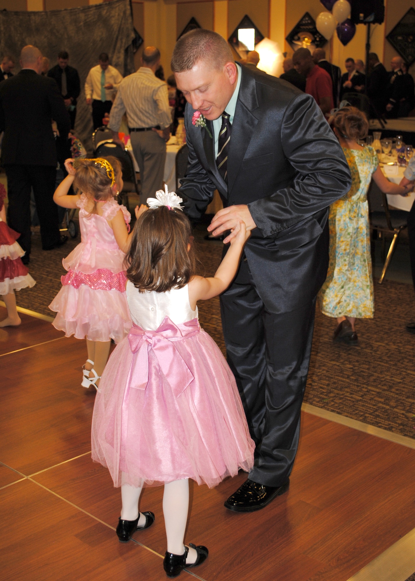 Tech. Sgt. Martin Hanenburg, 490th Missile Squadron alert facility manager, dances with his daughter, Haylee, at the Father and Daughter Dance.  According to Hanenburg, "It was a special night that I felt that I owed to my little girl because of the amount of time in her young life that I have missed due to deployments and TDYs while being part of the 819th RED HORSE Squadron.  I feel as though it will be a great memory she will have for the rest of her life." (U.S. Air Force photo/Senior Airman Cortney Paxton)
