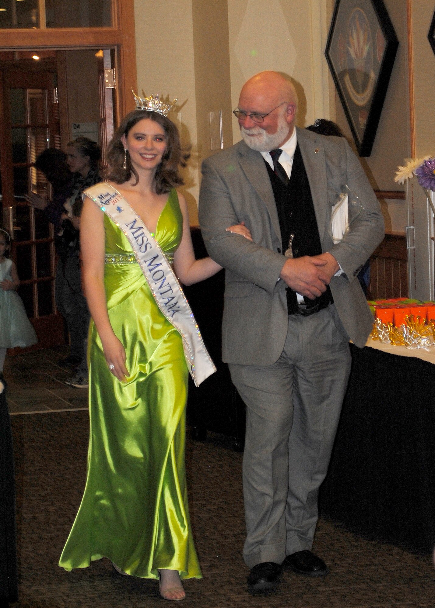 Alexis Wineman, Miss Monana, is escorted by her father, Michael Wineman, into the Grizzly Bend during the Father and Daughter Dance on March 15.  Before her appearance at the dance, Miss Montana had a chance to witness a K-9 demonstration on base.  (U.S. Air Force photo/Senior Airman Cortney Paxton)