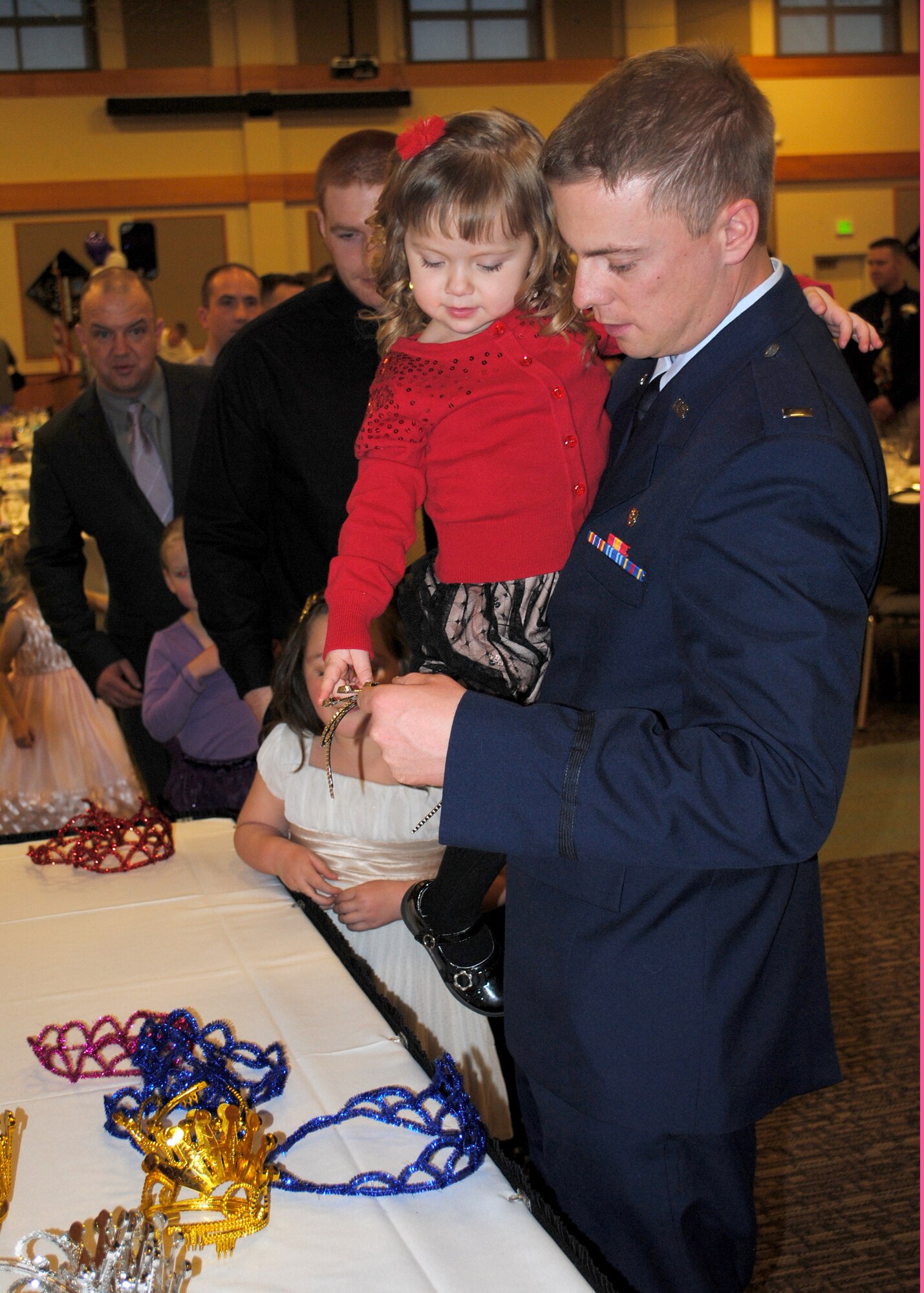1st Lt. Brian Schruth, Montana Air National Guard 120th Medical Group member, helps his daughter pick out a crown to wear at the dance.  Schruth and his daughter were two of 270 people who attended the event.  (U.S. Air Force photo/Senior Airman Cortney Paxton)