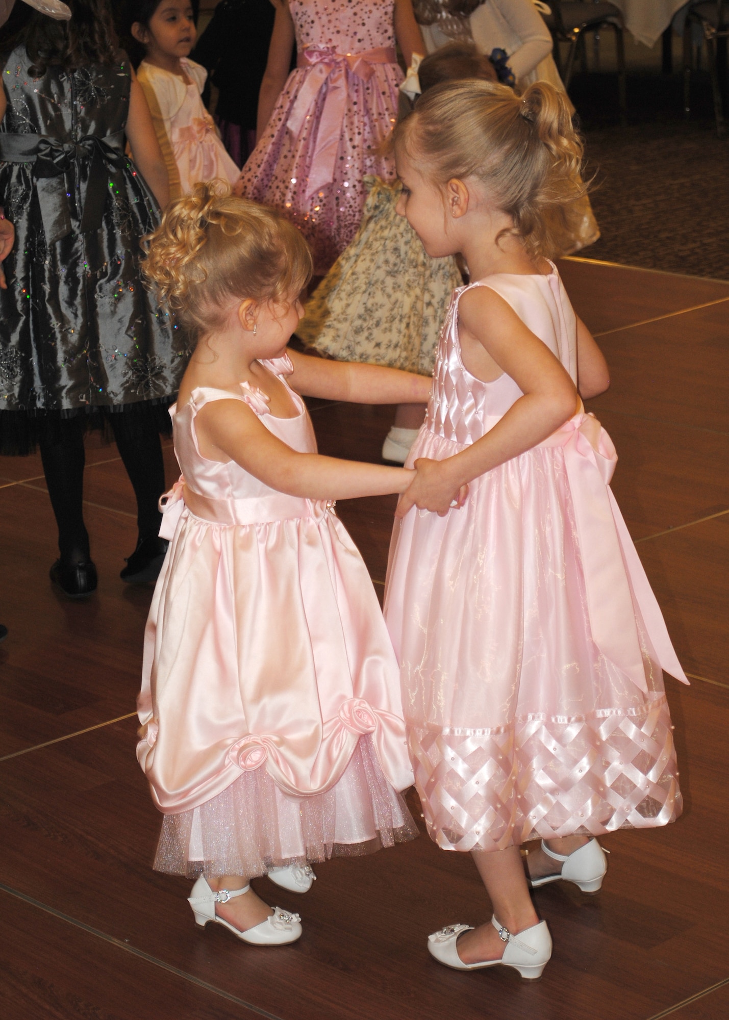 Sisters, Ayliana (right) and Kaylee; daughters of Staff Sgt. Andrew Deadmond, 341st Logistics Readiness Squadron member; dance with each other on the dance floor set up at the Father and Daughter Dance.  While the event allowed fathers to spend time with their daughters, it was also a chance for the children on base to make new friends.  (U.S. Air Force photo/Senior Airman Cortney Paxton)