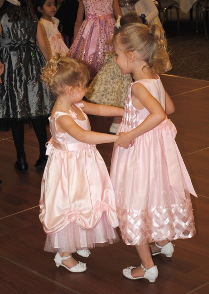 Sisters, Ayliana (right) and Kaylee; daughters of Staff Sgt. Andrew Deadmond, 341st Logistics Readiness Squadron member; dance with each other on the dance floor set up at the Father and Daughter Dance.  While the event allowed fathers to spend time with their daughters, it was also a chance for the children on base to make new friends.  (U.S. Air Force photo/Senior Airman Cortney Paxton)