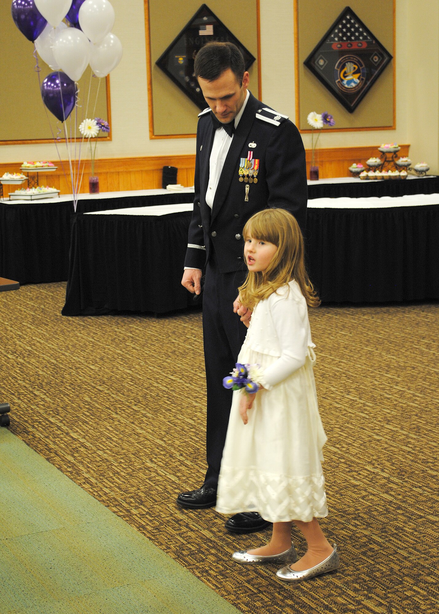 Lt. Col. Tom Vance, 341st Missile Maintenance Squadron commander, and his daughter look for their seats at the Father and Daughter Dance on March 15.  The formal dance was a great way for fathers to have some fun, personal time with their daughters.  (U.S. Air Force photo/Senior Airman Cortney Paxton)