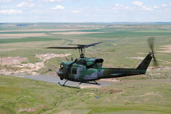 A 40th Helicopter Squadron flight crew flies a UH-1N Huey Iroquois over Montana's landscape.  A four-person crew recently assisted the Cascade County Sheriff’s Department in finding a missing man.  (U.S. Air Force photo/Senior Airman Cortney Paxton)