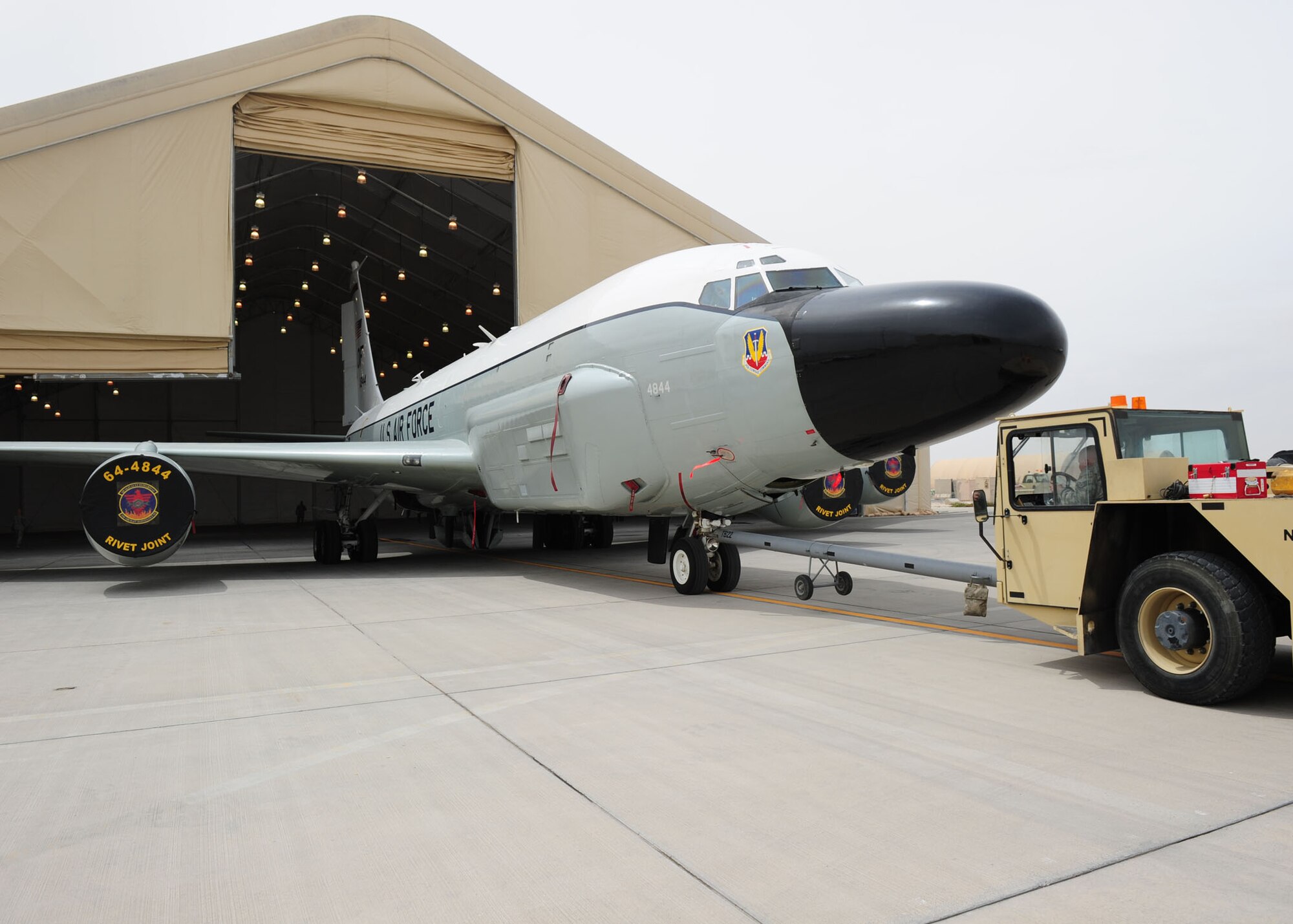 SOUTHWEST ASIA -- Members of the 763rd Expeditionary Aircraft Maintenance Unit move a RC-135 Rivet Joint into the expeditionary hanger for maintenance. The 763rd EAMU is part of the 379th Expeditionary Aircraft Maintenance Squadron and is responsible for maintaining the RC-135 Rivet Joint. (U.S. Air Force photo/Master Sgt. Brendan Kavanaugh)