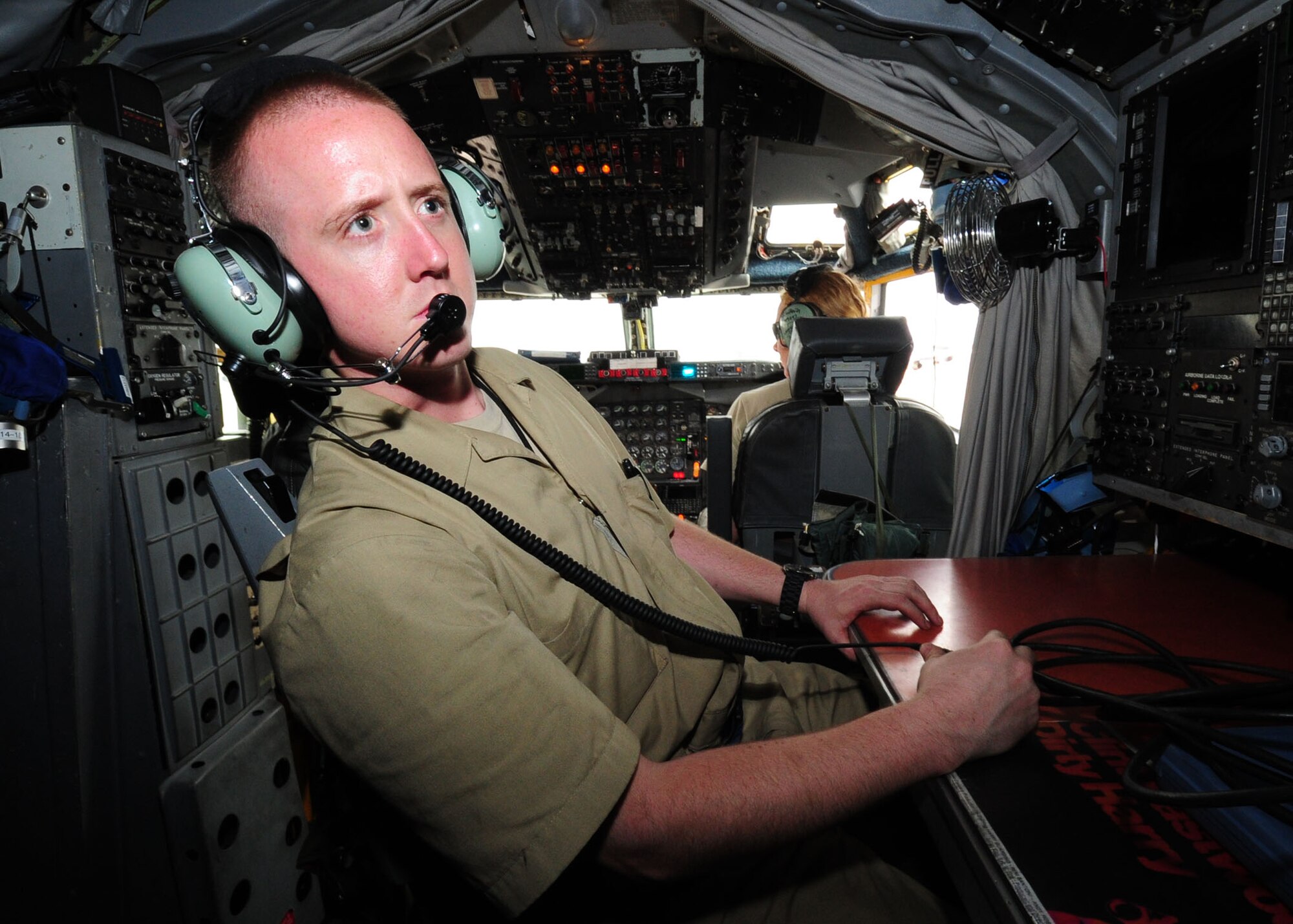 SOUTHWEST ASIA -- Airman 1st Class Colton Johnston, dedicated crew chief with the 763rd Expeditionary Aircraft Maintenance Unit, looks at the engineer's board on an RC-135 Rivet Joint while preparing for an engine test. The 763rd EAMU is part of the 379th Expeditionary Aircraft Maintenance Squadron and is responsible for maintaining the RC-135 Rivet Joint. (U.S. Air Force photo/Master Sgt. Brendan Kavanaugh)