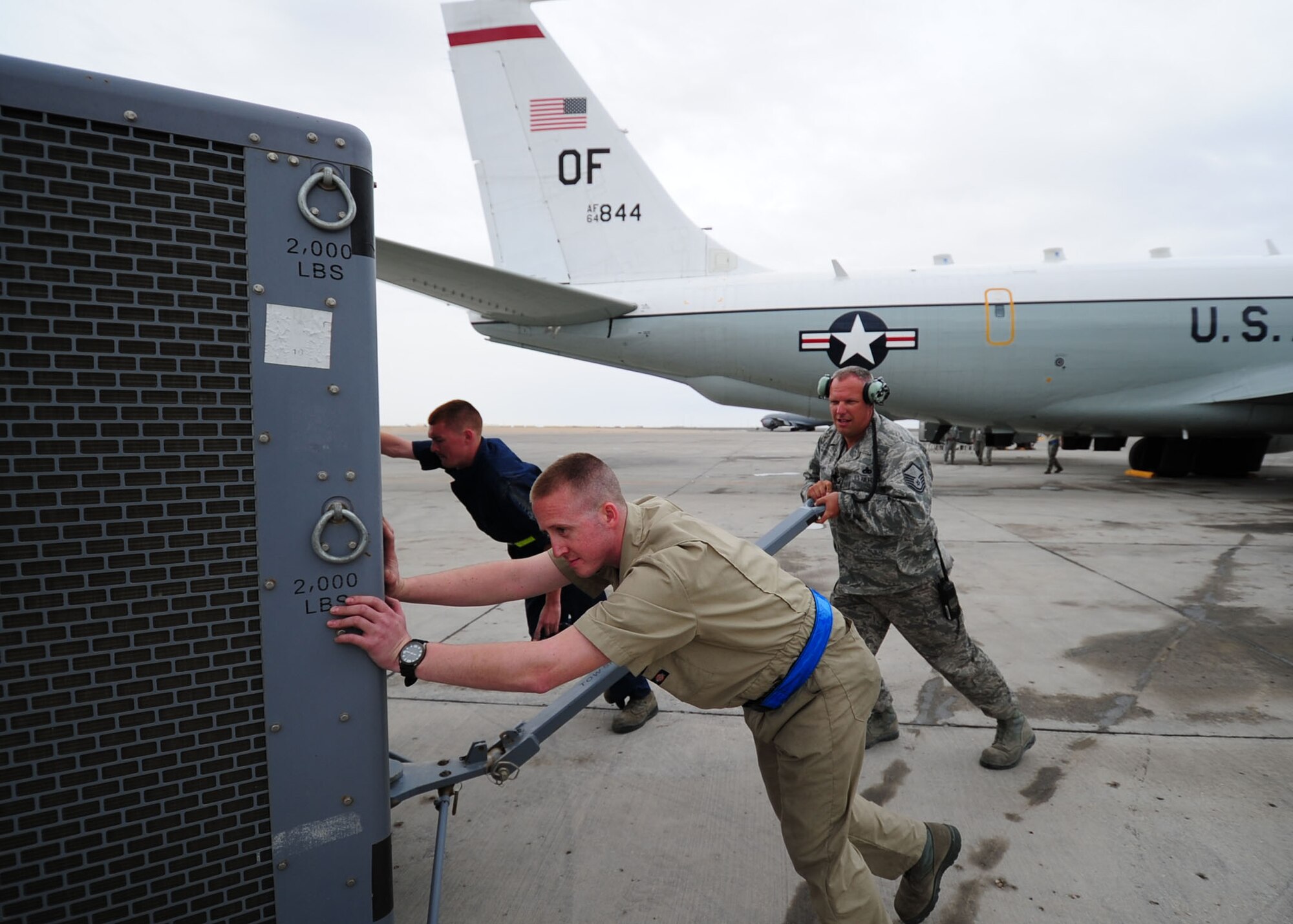 SOUTHWEST ASIA -- Members of the 763rd Expeditionary Aircraft Maintenance Unit move an aircraft generator out of the way prior to an engine test on an RC-135 Rivet Joint. The 763rd EAMU is part of the 379th Expeditionary Aircraft Maintenance Squadron and is responsible for maintaining the RC-135 Rivet Joint. (U.S. Air Force photo/Master Sgt. Brendan Kavanaugh)
