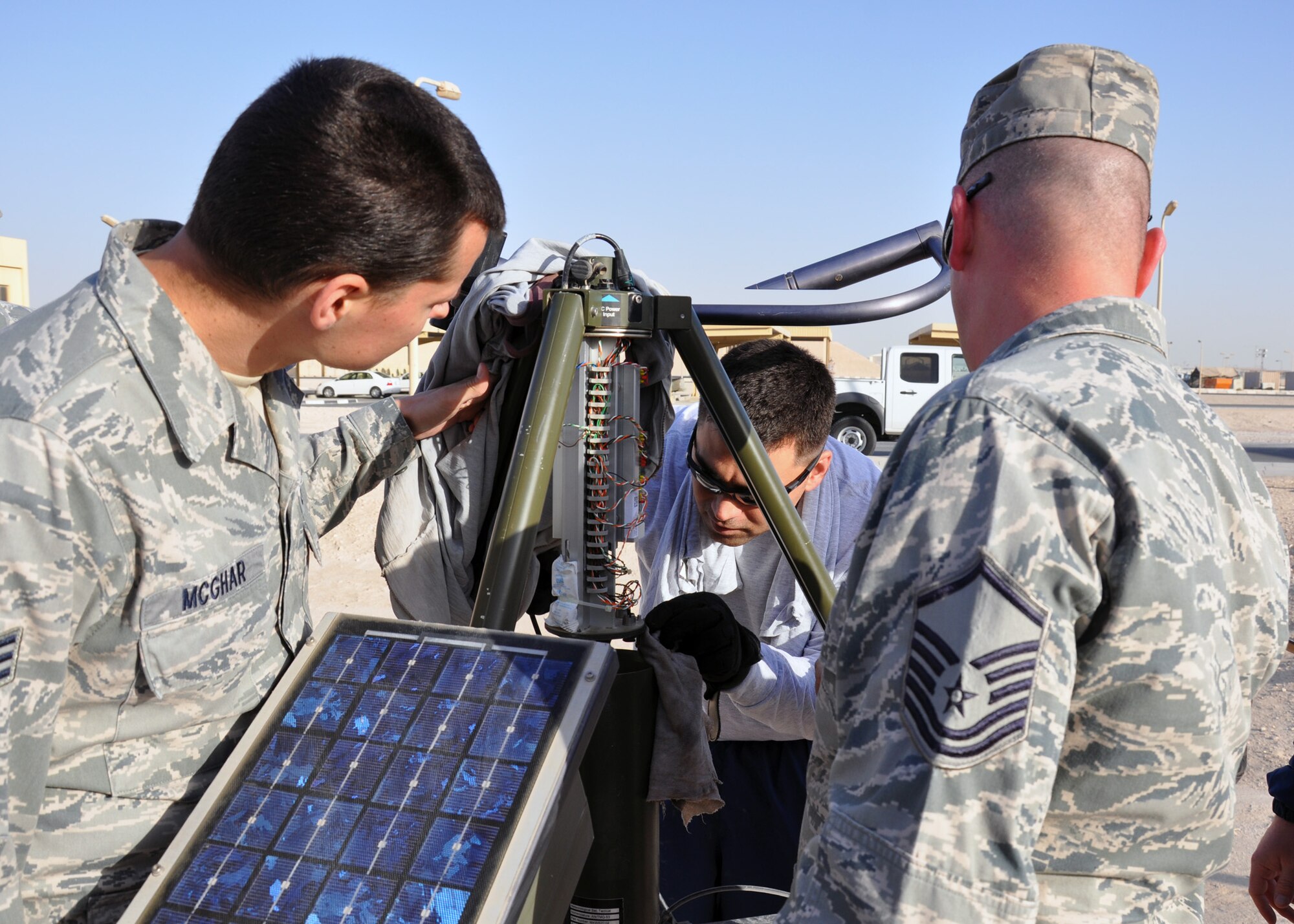 Members of the 379th Expeditionary Operations Support Squadron Weather Flight inspect the condition of the barometer and central processing unit on the Tactical Meteorological Observing System-53 during quarterly maintenance and inspection. The TMQ-53 is a low-earth orbiting satellite to enable the transmission of mission-critical weather data. (U.S. Air Force Photo/Capt. Angela Webb)