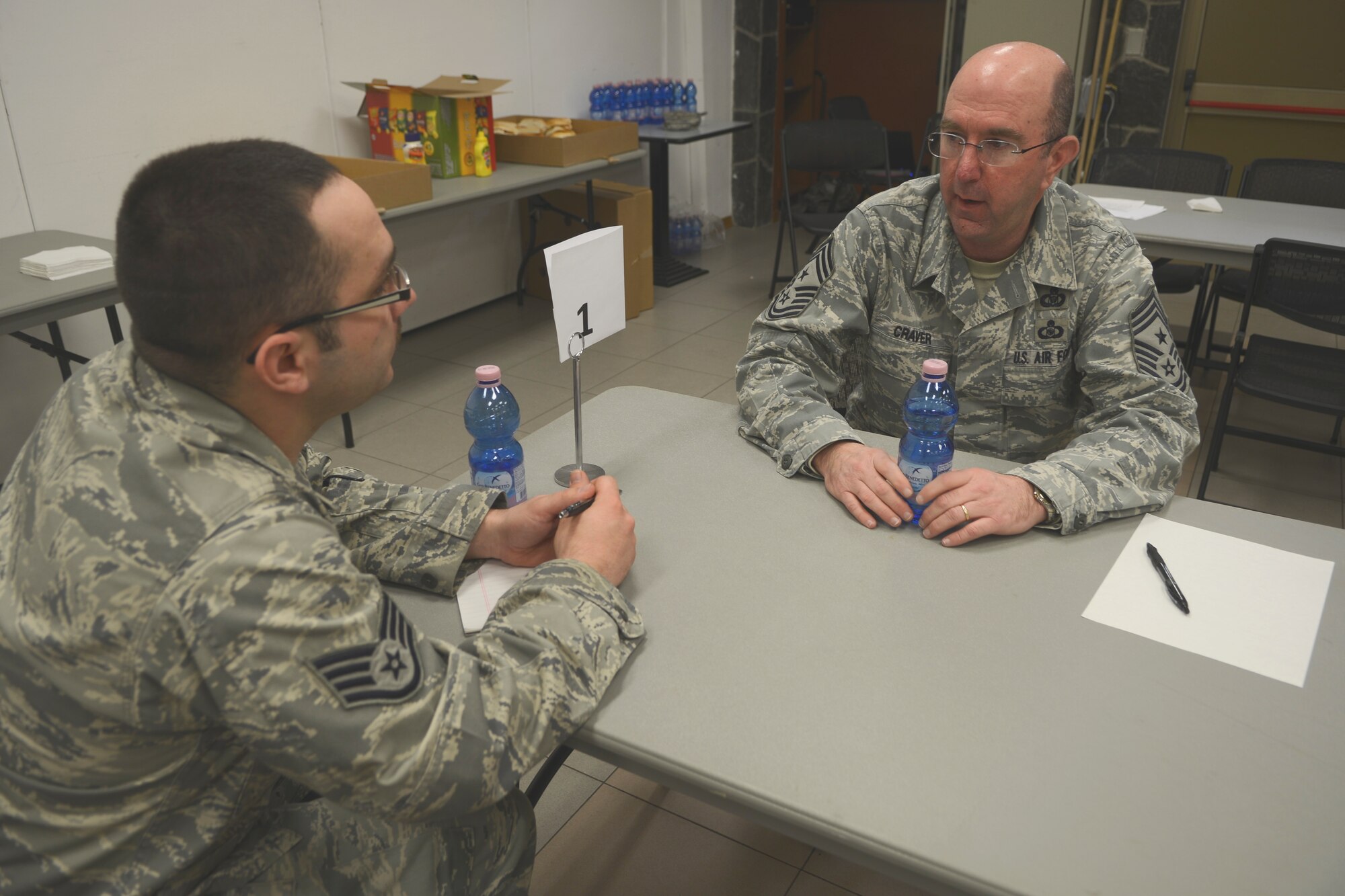 Staff Sgt. Michael Babcock, 31st Civil Engineer Squadron structures technician, talks with Chief Master Sgt. Jeffrey Craver, 31st Fighter Wing command chief during the “Top 3 Lunch and Learn” speed mentorship event at Aviano Air Base, Italy, March 20, 2013. The event gave senior enlisted members a chance to mentor and answer questions from Airmen. (U.S. Air Force photo /Senior Airman Jessica Hines)