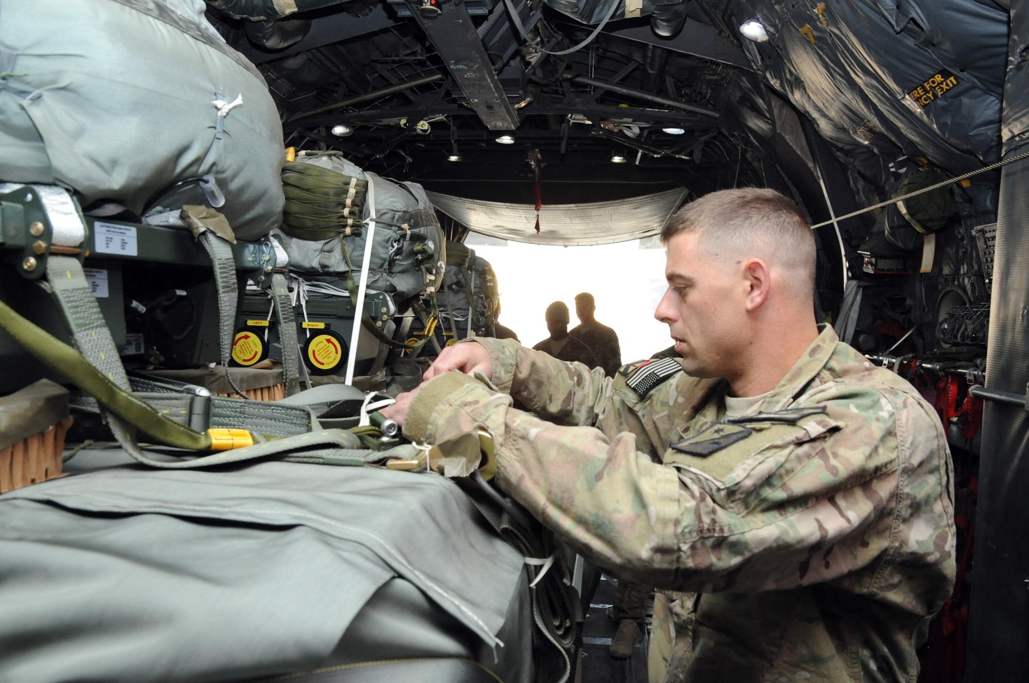 U.S. Army Spc. Courtney Williams, 647th Quartermaster Detachment rigger, makes pre-flight checks on a set of Joint Precision Airdrop System pallets aboard a C-130 Hercules on Bagram Airfield, Afghanistan, March 21, 2013. The 774th Expeditionary Airlift Squadron recently tested a new technique expected to greatly increase the efficiency of airdrops both downrange and elsewhere. (U.S. Air Force photo/Staff Sgt. David Dobrydney)