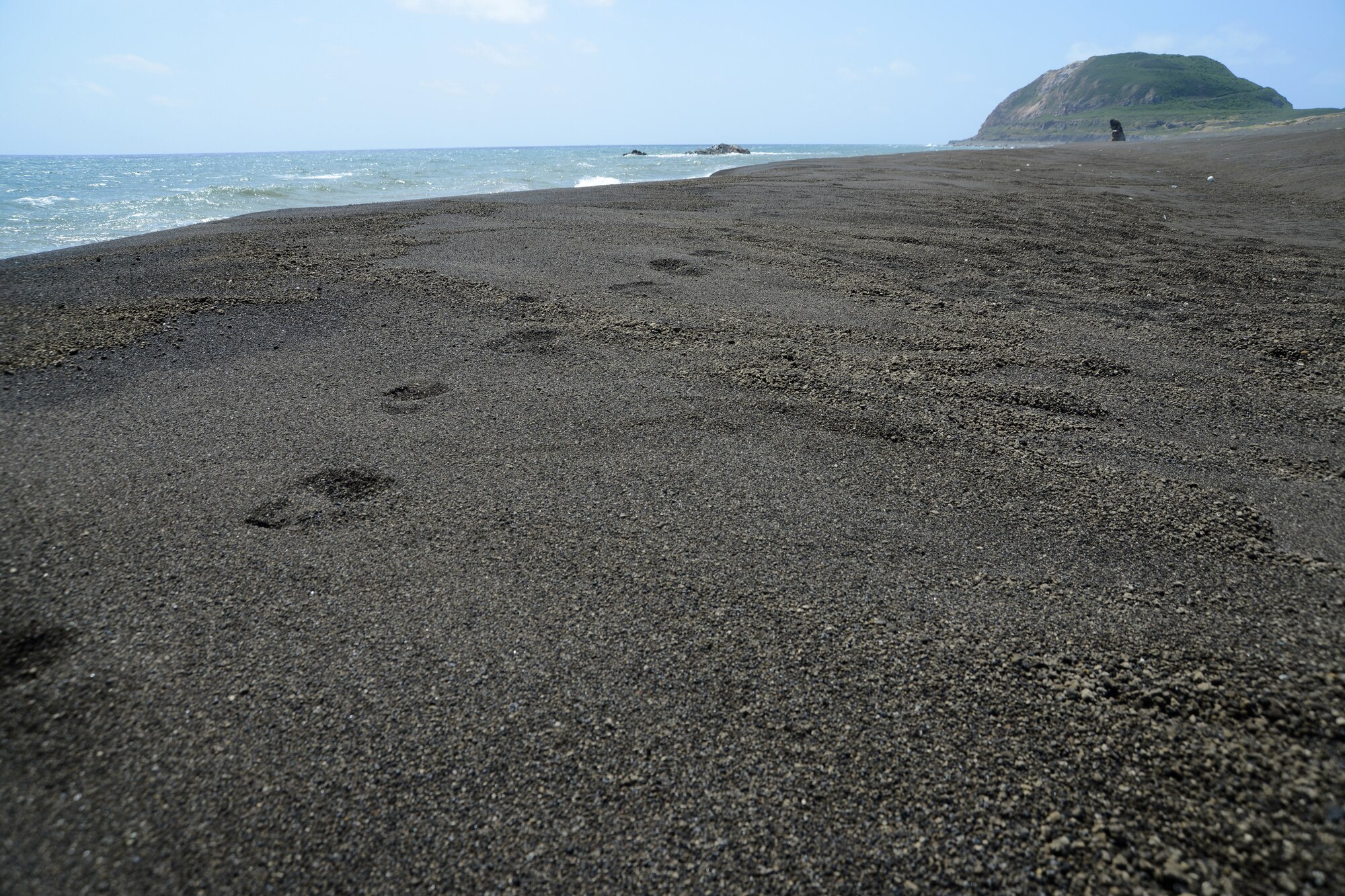 Fresh boot prints line the beach headed toward Mount Suribachi on Iwo To, Japan, formerly known as Iwo Jima. Members of the 18th Medical Group hosted a professional development trip to the island for about 40 of its Airmen on March 18, 2013. (U.S. Air Force photo/Tech Sgt. Jocelyn L. Rich-Pendracki)