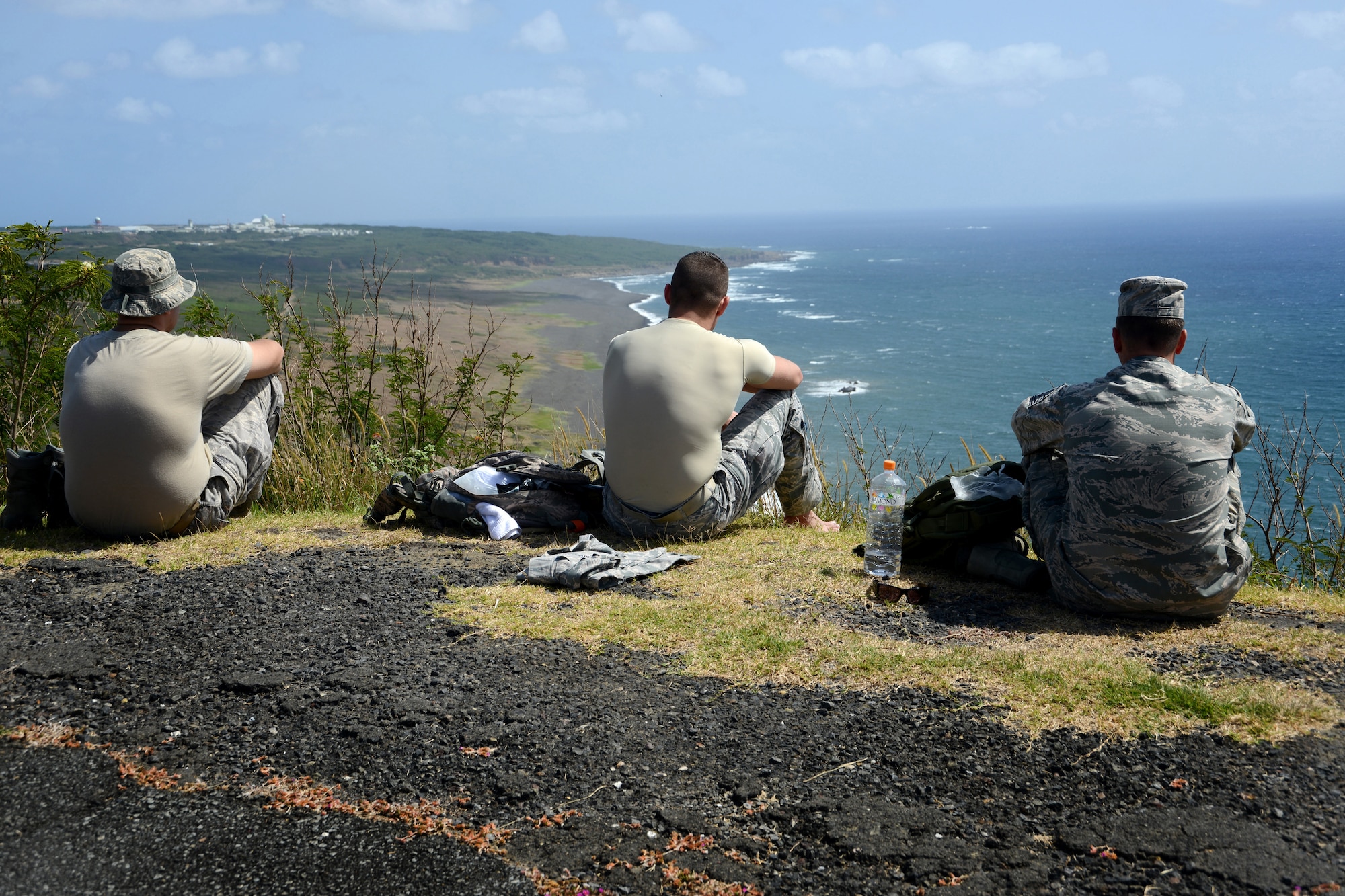 Members of the 18th Medical Group look out over the edge of Mount Suribachi after having hiked to the top during a professional development trip to Iwo To, Japan, formerly known as Iwo Jima, March 18, 2013. The trip included about 40 Airmen who took part in an approximate 10-mile hike along the beaches where the Battle of Iwo Jima was fought, to the memorial commemorating those who fought and died on the island 68 years ago. (U.S. Air Force photo/Tech Sgt. Jocelyn L. Rich-Pendracki)