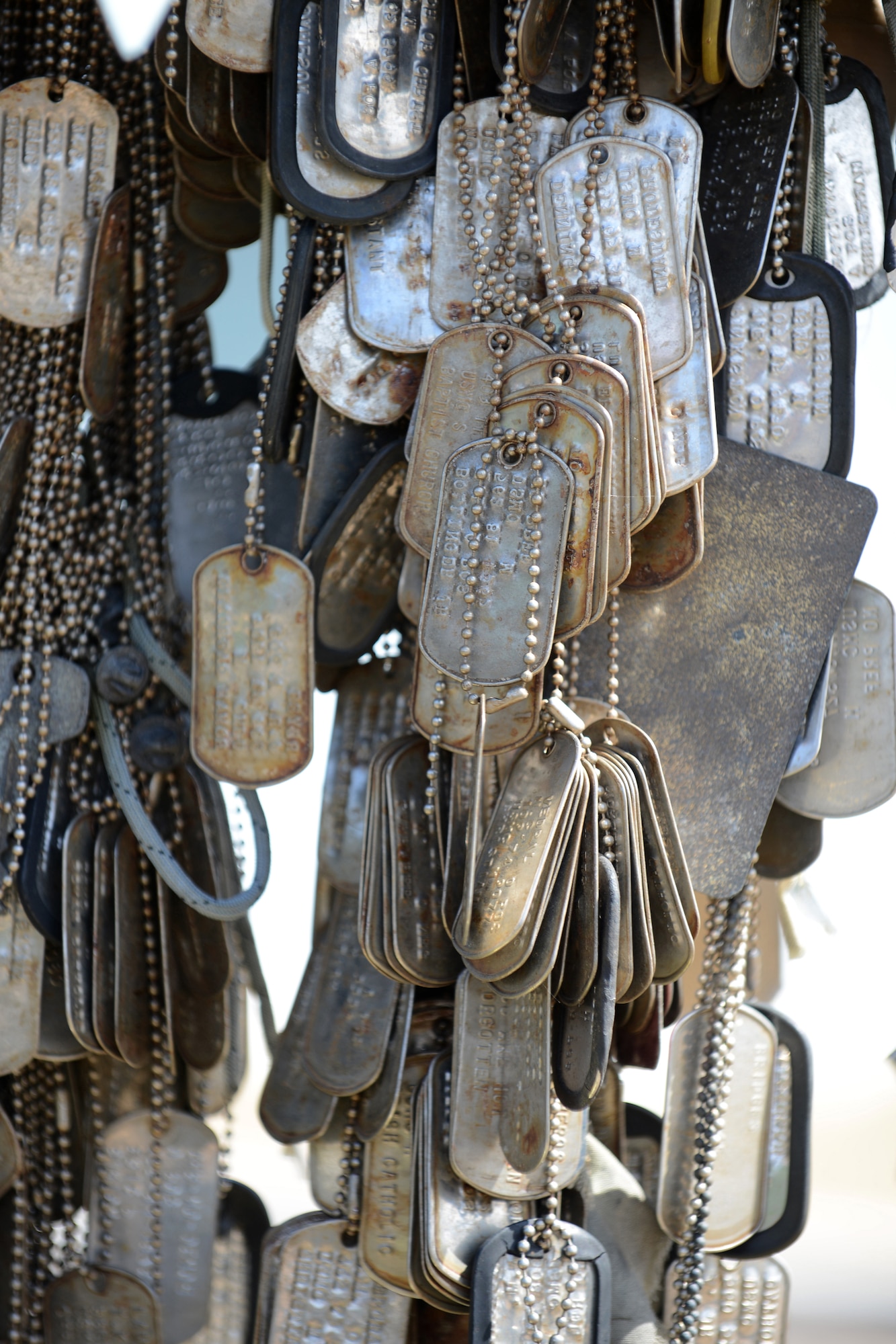 Dog tags and other trinkets are commonly left by visitors at the memorial at the top of Mount Suribachi to pay homage to those who fought and died there. Members of the 18th Medical Group toured Iwo To, Japan, formerly called Iwo Jima, as a professional development trip March 18, 2013. (U.S. Air Force photo/Tech Sgt. Jocelyn L. Rich-Pendracki)