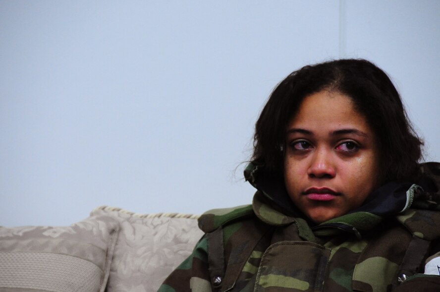 U.S. Air Force Airman 1st Class Kenna Jackson, 35th Fighter Wing Public Affairs photojournalist, sits quietly after being notified that a simulated family death occurred during an Operational Readiness Exercise at Misawa Air Base, Japan, March 22, 2013.  Base chaplains are readily available for situations like this and provide comfort and guidance to both military and civilian members in need at a moment’s notice.  (U.S. Air Force photo by Staff Sgt. April Quintanilla)