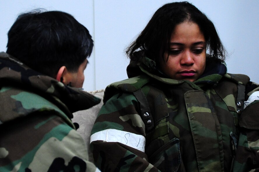 U.S. Air Force Airman 1st Class Kenna Jackson (right), 35th Fighter Wing Public Affairs photojournalist, talks with Capt. Antonio Rigonan, 35th FW chaplain, after being notified that a  simulated family death occurred during an Operational Readiness Exercise at Misawa Air Base, Japan, March 22, 2013.  The base chaplains are readily available to provide spiritual comfort and guidance to both military and civilian members in need at a moment’s notice.  (U.S. Air Force photo by Staff Sgt. April Quintanilla)