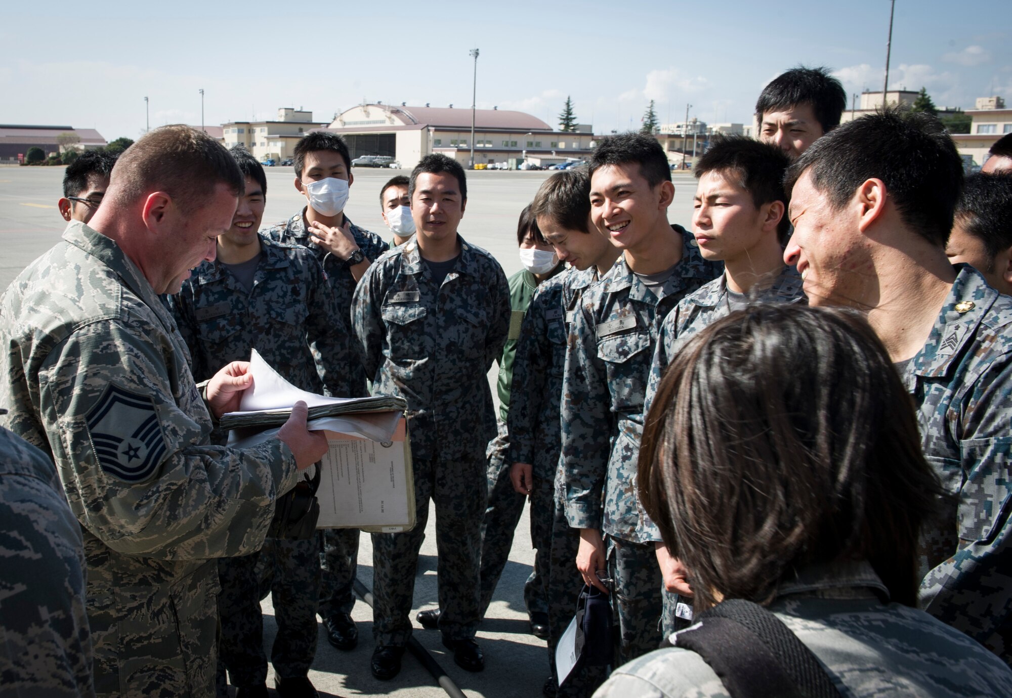 YOKOTA AIR BASE, Japan -- Senior Master Sgt. Gregory Lily, 374th Aircraft Maintenance Squadron lead production superintendent, shows an example of a pre-flight inspection checklist to Japan Air Self-Defense Force maintenance officer cadets visiting Yokota Air Base, Japan, from the 1st Technical School at Hamamatsu Air Base, Japan, March 19, 2013.  During the visit, JASDF members visited multiple aircraft maintenance facilities to take a glimpse of everyday operations, ask questions to technicians and get hands on experience with equipment before graduating technical school. (U.S. Air Force photo by Senior Airman Andrea Salazar)