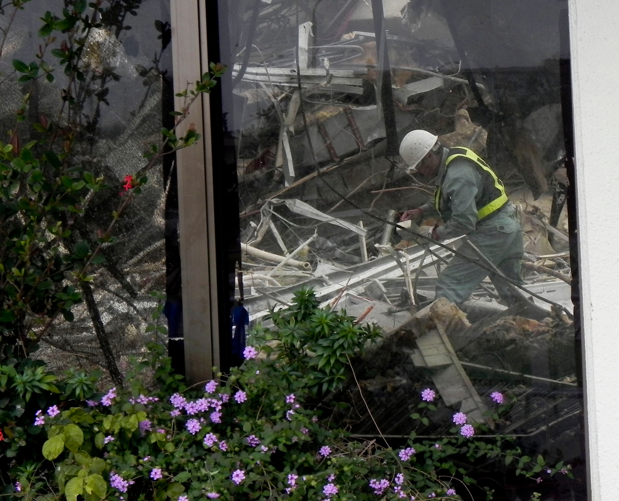 A Japanese contractor works at the demolition site of Building 429, the old food court adjacent from the Hershey Temporary Lodging Facility, on Kadena Air Base, Japan, March 14, 2013. The 18th Contracting Squadron is in charge of a base-wide project to demolish old buildings and make room for new establishments. (U.S. Air Force photo/Christina Thompson)