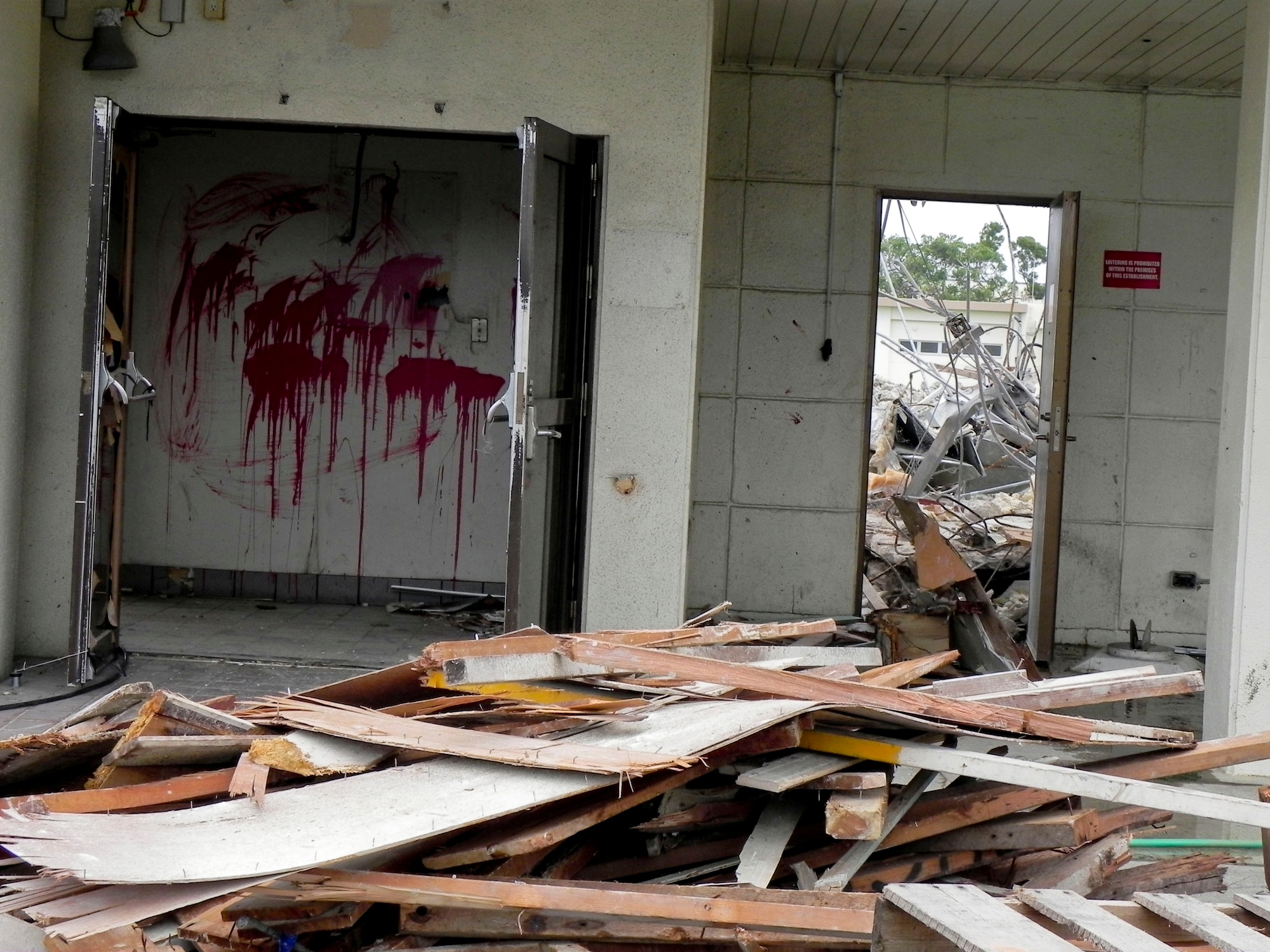 Building 429, adjacent from the Hershey Temporary Lodging Facility on Kadena Air Base, Japan, sits under the process of demolition by Japanese contractors March 14, 2013. The 18th Contracting Squadron is in charge of overseeing the project. (U.S. Air Force photo/Christina Thompson)