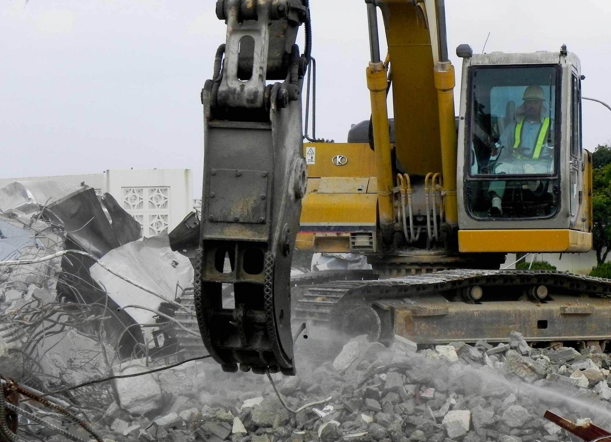 A Japanese contractor demolishes Building 429 by the Hershey Temporary Lodging Facility on Kadena Air Base, Japan, March 14, 2013. The building was once the Kadena food court. (U.S. Air Force photo/Christina Thompson)