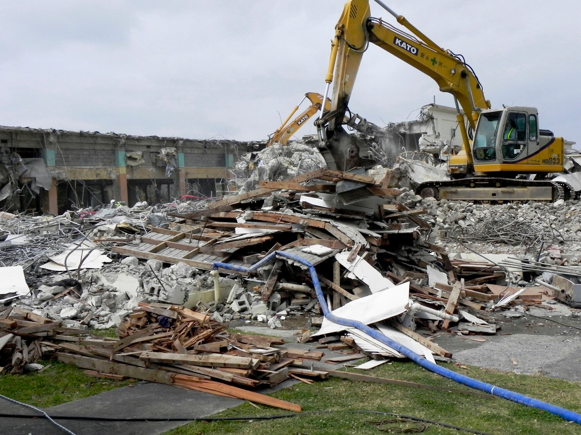 Japanese contractors work on demolishing Building 429, adjacent from the Hershey Temporary Lodging Facility on Kadena Air Base, Japan, March 14, 2013. The 18th Contracting Squadron is in charge of overseeing the demolition of the old food court to make room for a new establishment. (U.S. Air Force photo/Christina Thompson)
