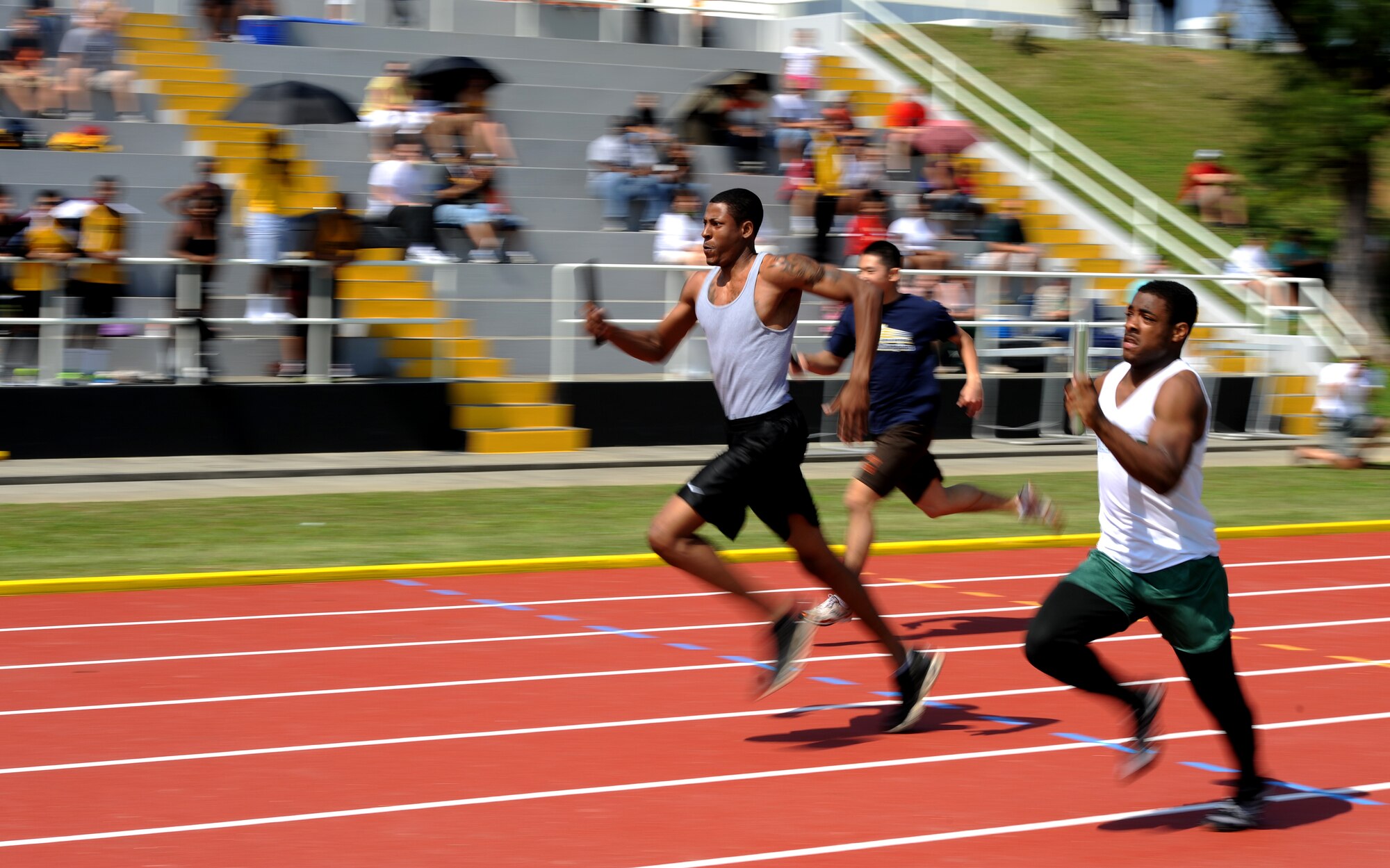 U.S. Air Force Airman 1st Class Justin Veazie competes in the distance medley during the first-ever island-wide track meet hosted by the Air Force Sergeants Association, Chapter 1553, on Kadena Air Base, Japan, March 23, 2013. More than 325 active-duty, civilians and dependents from different bases and local schools on Okinawa came together to see who would claim the title of fastest on the island. (U.S. Air Force photo/Staff Sgt. Laszlo Babocsi)