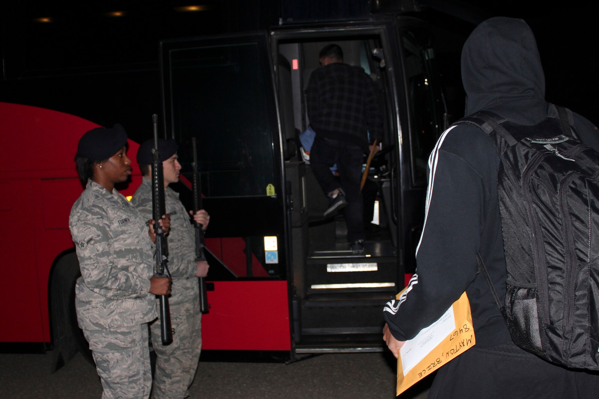 VANDENBERG AIR FORCE BASE, Calif. – Members of the 30th Security Forces Squadron honor guard present arms to 12 of their deployers as they board a bus here Sunday, March 24, 2013. Twelve 30th SFS members left the base at 2 a.m. bound for a deployed location in Southeast Asia. (U.S. Air Force photo/2nd Lt. Kaylee Ausbun)