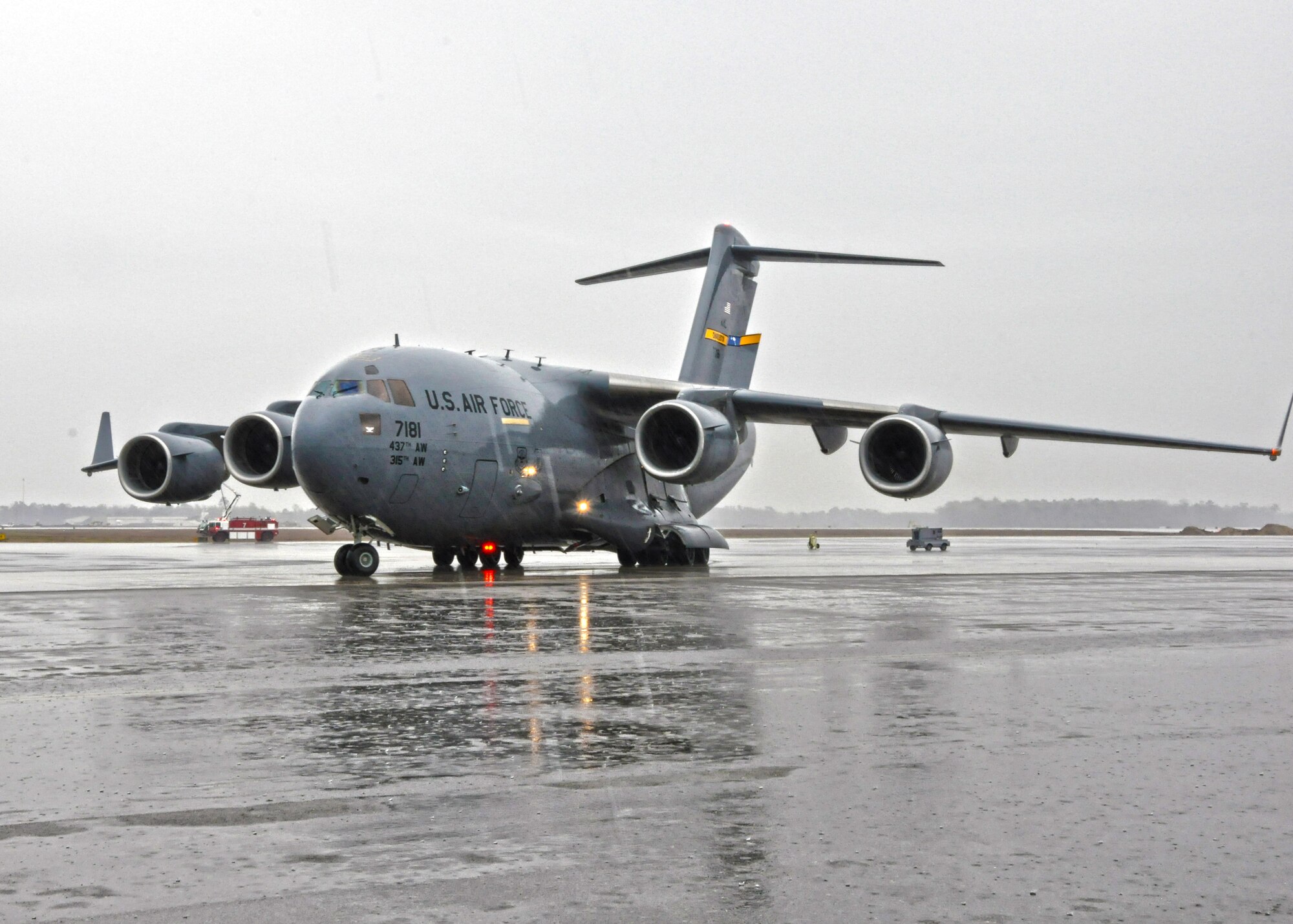 Col. Russell Fingar, 315th Airlift Wing vice commander, taxis a C-17 Globemaster III to its parking spot during his fini flight March 23, 2013 at Joint Base Charleston, S.C.  Fingar’s “fini flight” served as a final aviation salute to the colonel and his more than 26 years of service in the U.S. Air Force. Fingar will officially retire from the USAF April 01, 2013. (U.S. Air Force Photo/Staff Sgt. Shane Ellis)