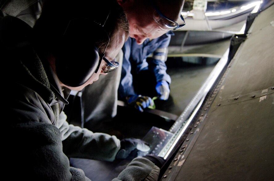 During the B drill weekend, Westover sheet metal technicians, MSgt. Daniel Sullivan, TSgt. Sam Kirkland, and SrA. Nigel Dallaire, work to repair small sections inside the tail section of the C-5 Galaxy. (U.S. Air Force photo/SrA. Alexander Brown)