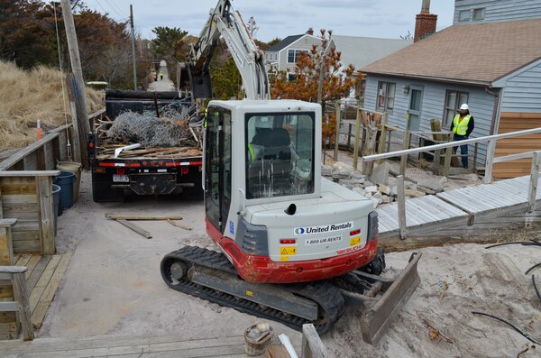 Contract workers remove Hurricane Sandy debris from Ocean Beach, N.Y., on Fire Island March 17, 2013. The U.S. Army Corps of Engineers is overseeing the removal of storm debris on Fire Island as part of the federal government’s Hurricane Sandy response and recovery efforts. (U.S. Army photo by Chris Gray-Garcia/Released)