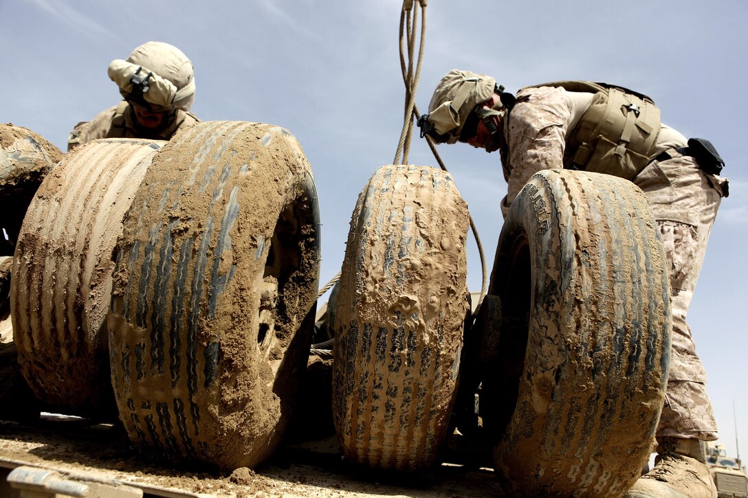 U.S. Marines with Rolling Thunder 1, Transportation Support Company, Combat Logistics Regiment 2, assist Marines with 3rd Battalion, 9th Marines, tie up a damaged mine roller during a combat logistics patrol (CLP) to forward operating base (FOB) Payne, Helmand province, Afghanistan, March 23, 2013. Rolling Thunder 1 conducted the CLP to facilitate the demilitarization of FOB Payne. (U.S. Marine Corps photo by Sgt. Anthony L. Ortiz / Released) 