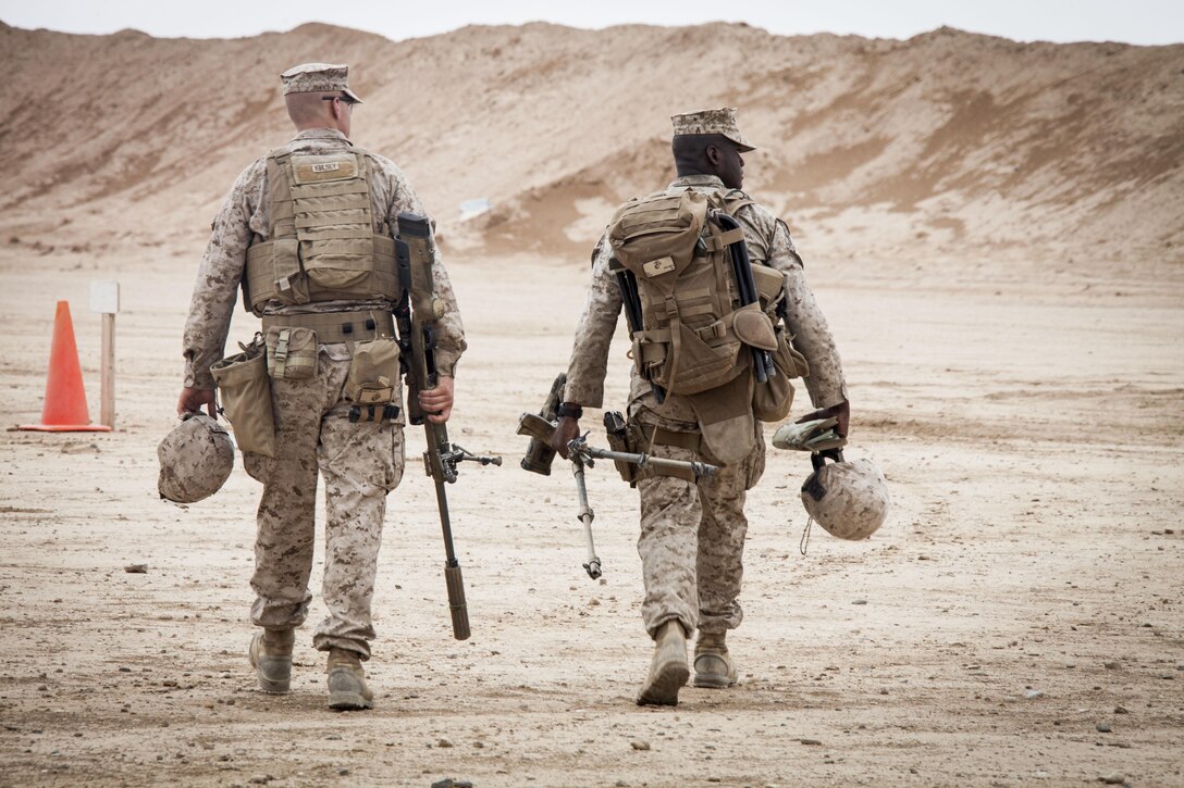 U.S. Marine Cpl. Darek Kelsey, left, and Lance Cpl. William Tipper both scout snipers assigned to 3rd Battalion, 4th Marine Regiment, make their way to the firing line at a live fire range on Camp Leatherneck, Helmand Province, Afghanistan, March 23, 2013.  The Marines were there to calibrate their weapons before pushing forward to conduct combat operations in support of Operation Enduring Freedom.  (U.S. Marine Corps photo by Staff Sgt. Ezekiel R. Kitandwe/Released)