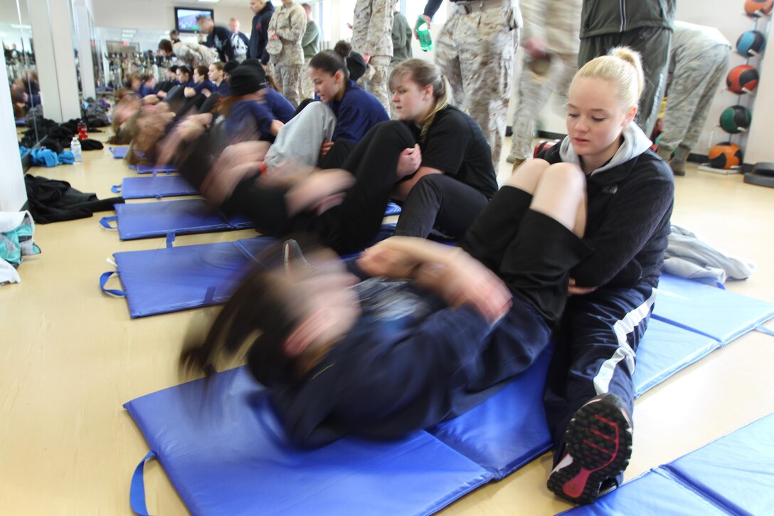 Female Poolees, women currently enrolled in the Marine Corps’ Delayed Entry Program, from Connecticut, Massachusetts, Rhode Island and Vermont, perform the sit-up portion of their Initial Strength Test on Westover Air Reserve Base, March 23, 2013. The Poolees spent the day conducting their IST and practicing Marine Corps drill. (U.S. Marine Corps Photo by Sgt. Richard Blumenstein)