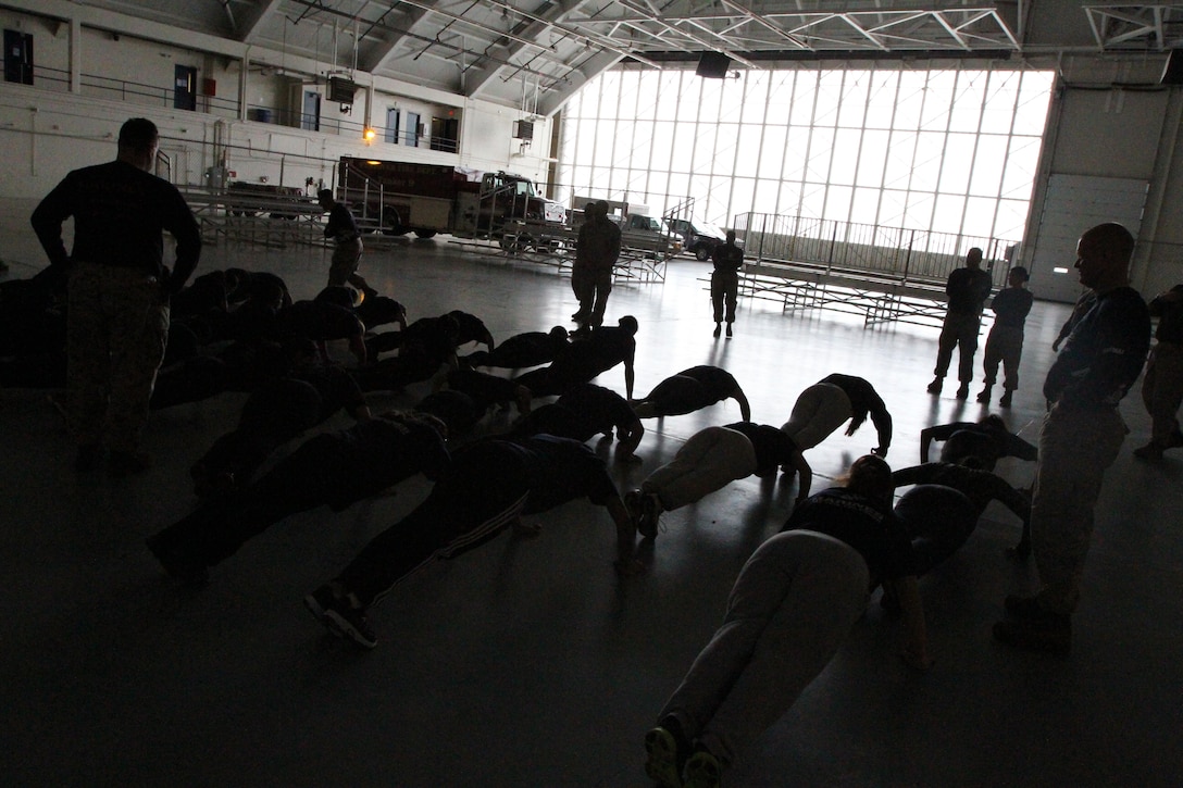 Female Poolees, women currently enrolled in the Marine Corps’ Delayed Entry Program, from Connecticut, Massachusetts, Rhode Island and Vermont, preform pushups inside a hanger bay on Westover Air Reserve Base, March 23, 2013. The Poolees spent the day conducting their Initial Strength Test and practicing Marine Corps drill. (U.S. Marine Corps Photo by Sgt. Richard Blumenstein)