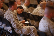 A Marine with 2nd Marine Logistics Group signs an attendance roster during an information security class held aboard Camp Lejeune, N.C., March 18, 2013. The 2nd MLG hosted the course to help spread information about current threats to information security and prepare its Marines to protect sensitive information. 
