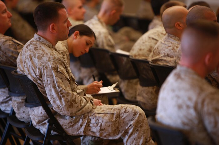 A Marine with 2nd Marine Logistics Group signs an attendance roster during an information security class held aboard Camp Lejeune, N.C., March 18, 2013. The 2nd MLG hosted the course to help spread information about current threats to information security and prepare its Marines to protect sensitive information. 