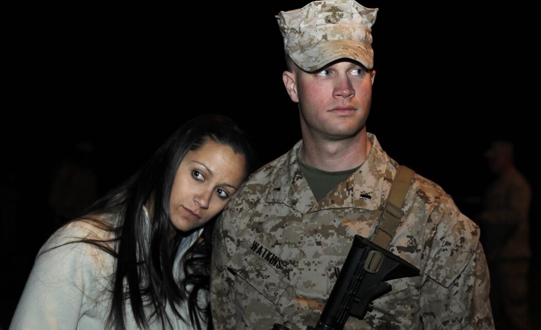 Jayshree Watkins leans on her husband, 1st Lt. John Watkins, Headquarters and Services Company, 3rd Battalion, 4th Marine Regiment, shortly before the company boarded the busses to deploy to Afghanistan March 12. The company deployed in support of Operation Enduring Freedom.