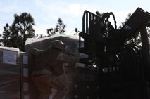 A Marine with 2nd Supply Battalion, Combat Logistics Regiment 25, 2nd Marine Logistics Group guides a forklift as it prepares to offload a pallet of supplies during a resupply operation with 10th Marine Regiment, 2nd Marine Division at Fort Bragg, N.C., March 14, 2013. Detachments from 2nd MLG formed a logistics combat element to support 10th Marines during the 19-day joint training exercise Rolling Thunder.