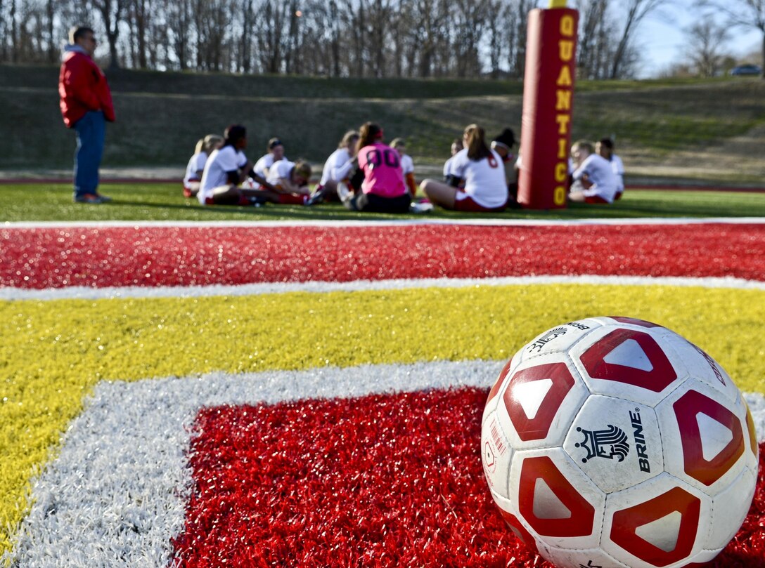 The Quantico Middle/High School Lady Warriors’ Soccer Team talks to their coach before the second half of their game against the Shenandoah Valley Christian Academy Patriots at Butler Stadium on March 22, 2013. The Patriots beat the Lady Warriors, 5-0.