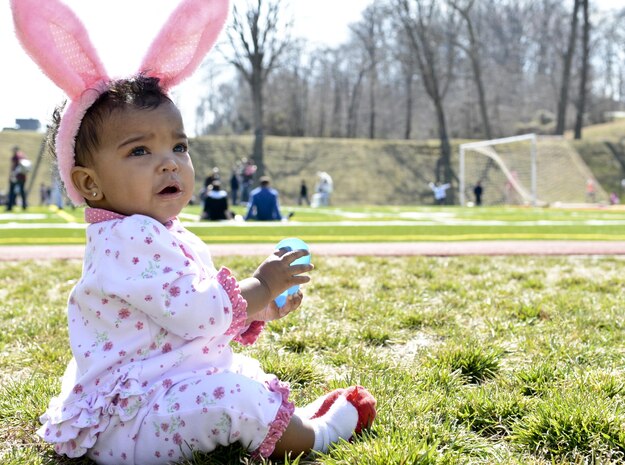 Garbriella, 11 months, plays with her plastic Easter egg during the Marine Corps Community Services’ Easter Eggstravaganza at Butler Stadium on March 23, 2013. The events for the Eggstravaganza included an Easter Egg hunt, spoon egg relay, egg decorating and egg toss.