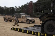 A Marine with 10th Marine Regiment, 2nd Marine Division carries water containers to his vehicle after filling them at a water tank, which belongs to 2nd Supply Battalion, Combat Logistics Regiment 25, 2nd Marine Logistics Group, during exercise Rolling Thunder at Fort Bragg, N.C., March 11, 2013. A logistics combat element from CLR-25 aided 10th Marines during the three-week joint training exercise with vehicle recovery, maintenance, resupply and refueling support. 