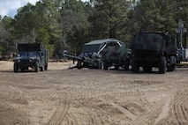 Tactical vehicles, which belong to 10th Marine Regiment, 2nd Marine Division, await repairs in front of the logistics combat element, or LCE, detachment from 2nd Marine Logistics Group March 17, 2013, during Rolling Thunder, a joint training exercise at Fort Bragg, N.C. The regiment depended on support from the LCE such as vehicle recovery, maintenance and resupply missions as it carried out its 19-day training. 