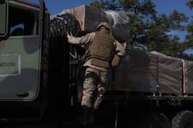A Marine with 2nd Supply Battalion, Combat Logistics Regiment 25, 2nd Marine Logistics Group unfastens pallets of Meals, Ready to Eat during a resupply mission for 10th Marine Regiment, 2nd Marine Division at Fort Bragg, N.C., March 14, 2013. The Marines with CLR-25’s logistics combat element supported 10th Marines with food, water, fuel and maintenance during Rolling Thunder, a biannual joint training exercise.