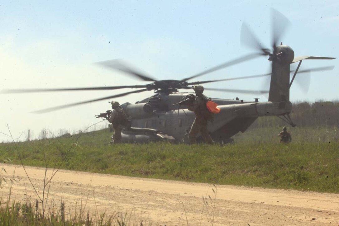 Marines with 1st Battalion, 4th Marine Regiment, 1st Marine Division, maneuver and prepare to board a CH-53 Super Stallion after successfully rescuing a simulated downed pilot during Tactical Rescue of Aircraft Personnel training, at Camp Pendleton, March 21. During the TRAP mission instructors with Special Operations Training Group observed and monitored how the Marines reacted to multiple combat scenarios. The TRAP mission provides Marines with real world scenarios to prepare them for deployment.