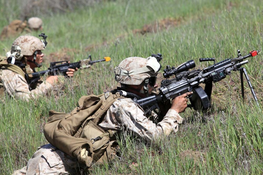 Marines with 1st Battalion, 4th Marine Regiment, 1st Marine Division, provide security while awaiting a helicopter extract after rescuing a simulated downed pilot during Tactical Rescue of Aircraft Personnel training, at Camp Pendleton, March 21. During the TRAP mission instructors with Special Operations Training Group observed and monitored how the Marines reacted to multiple combat scenarios. The TRAP mission provides Marines with real world scenarios to prepare them for deployment.